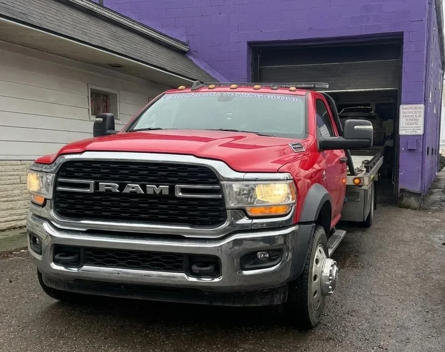 Prime O Towing red Ram 5500 flatbed tow truck at the shop before dispatch